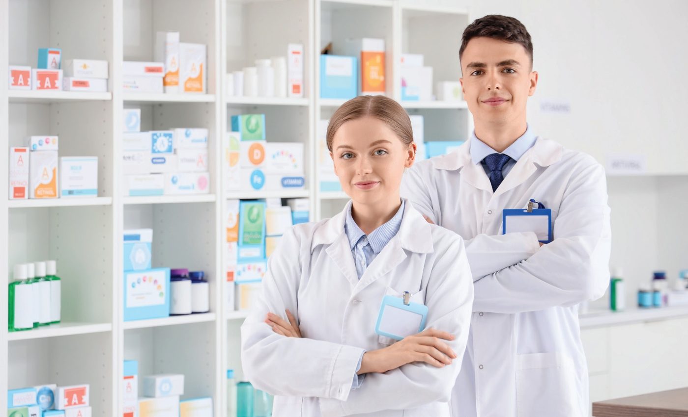 Two Wellcare pharmacists standing in a Wellcare Pharmacy dispensary
