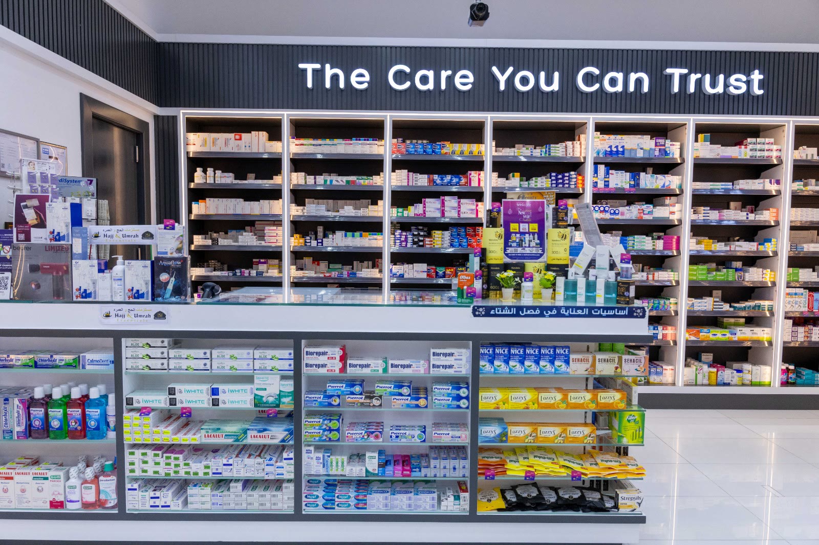 Pharmacist counter in front of the medicines wall